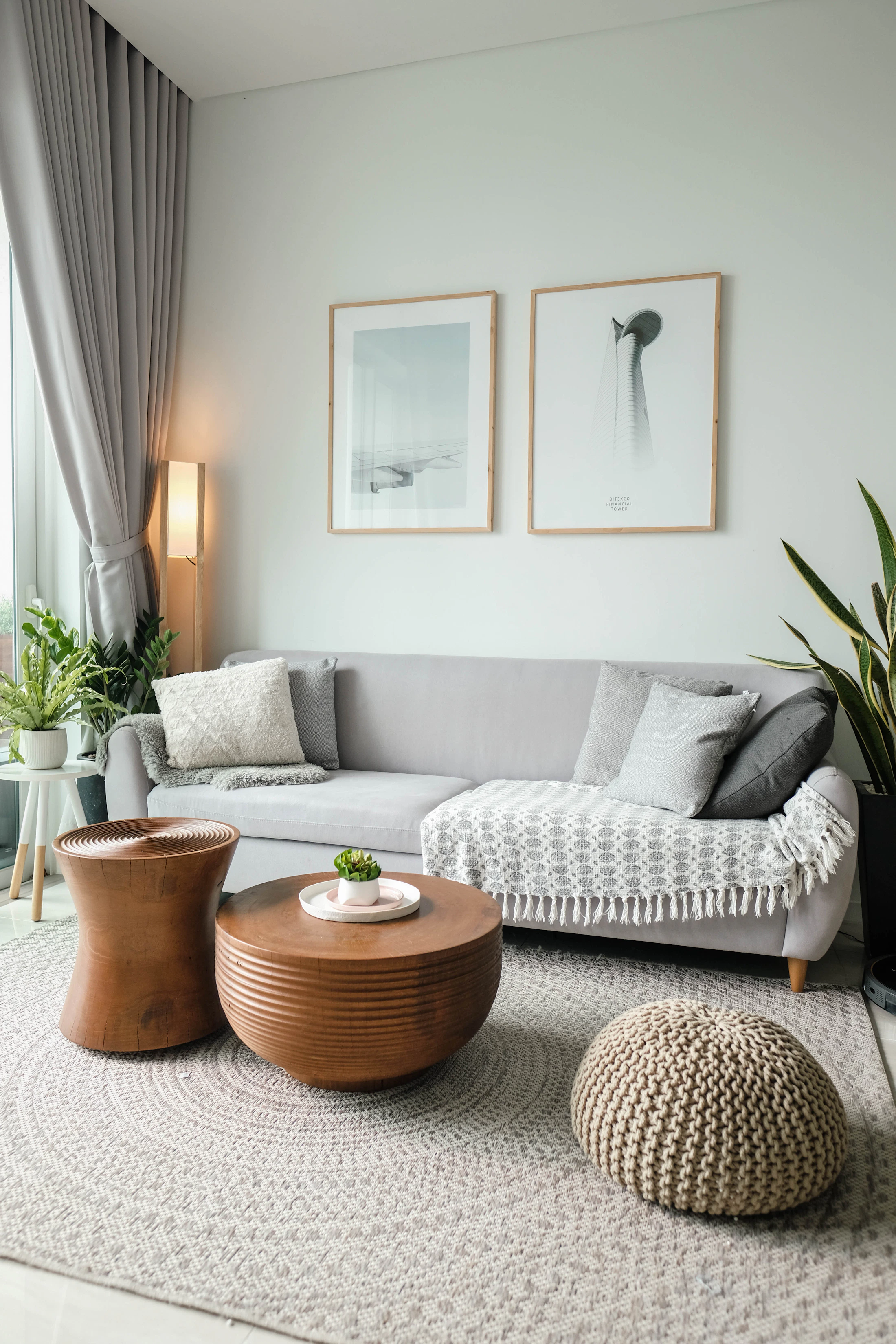 A furnished living room with a sofa and a large window